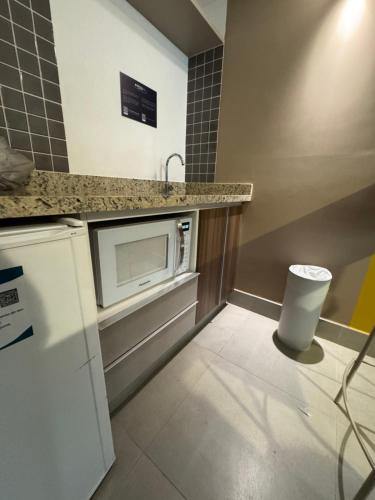 a kitchen with a sink and a microwave at Enjoy Olímpia Park Resort in Olímpia