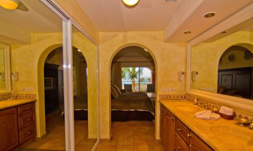 a bathroom with two sinks and a large mirror at Las Mañanitas LM E3303 in San José del Cabo