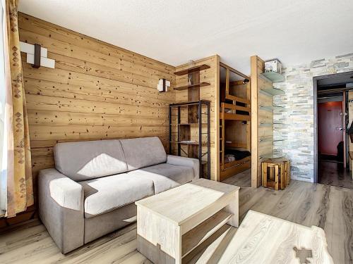 a living room with a couch and a table at Résidence Lac du Lou - Les Ménuires in Les Menuires