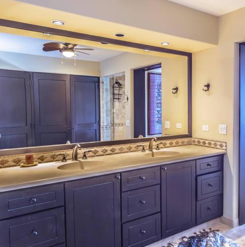 a bathroom with two sinks and a large mirror at Tortuga TBB 2401 in San José del Cabo