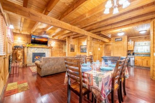 a dining room with a table and chairs and a fireplace at Above it All in Pigeon Forge