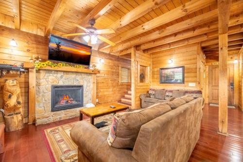 a living room with a couch and a fireplace at Above it All in Pigeon Forge