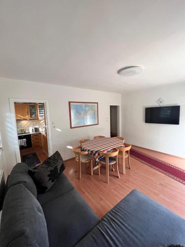 a living room with a couch and a table at Kisvölgy House in Eger