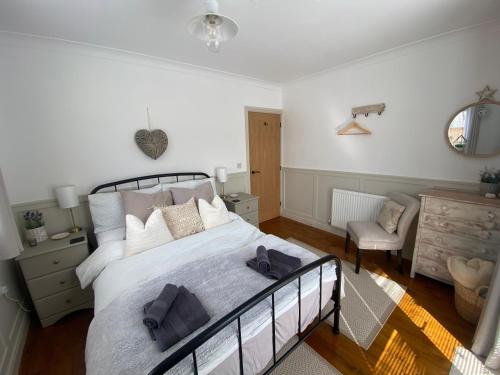 a bedroom with a bed with two towels on it at Tŷ Twt in Pontardawe