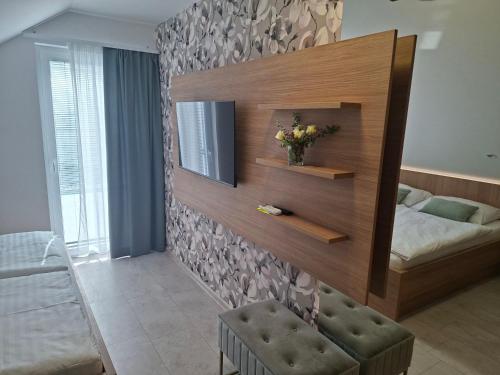 a bedroom with a mirror and a bed in it at BRIGITA Holiday Rooms - udobje, mir in sprostitev v bližini jezera in Gorica pri Slivnici