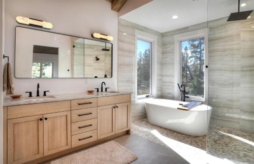 a bathroom with a tub and a large mirror at 2001 Lake Purgatory Drive in Durango