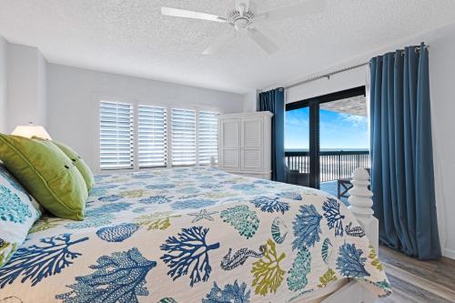a bedroom with a bed and a window with a view at Oceanfront with great beach views from all rooms & balcony, heated pool, and garage in Ormond-by-the-Sea