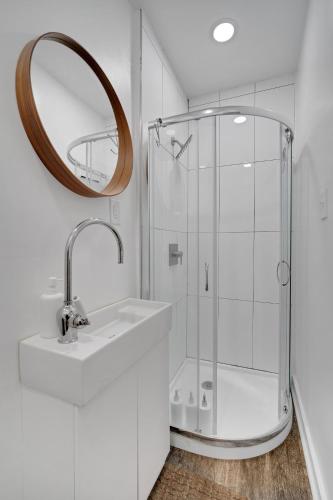 a bathroom with a shower and a sink and a mirror at The Twisty Nest on 17th in Philadelphia