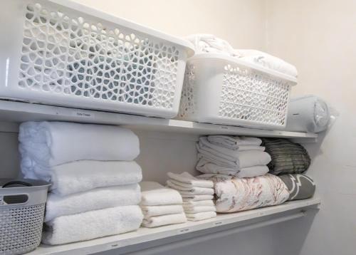 a closet with white towels and a bunch of towels at Town Treasure - Walkable - King Bed - AC in Christiansted