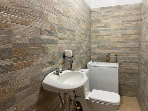 a bathroom with a toilet and a sink at Villa Keur Lune - Saly - SENEGAL in Saly Portudal