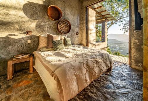 a bedroom with a large bed and a large window at House Cottage in Caribbean Mountains 2 