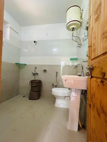 a bathroom with a toilet and a sink at Himalayan Baseraa in Sainj
