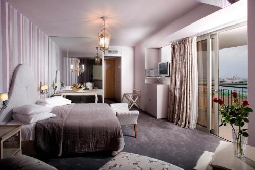 a bedroom with a bed and a living room at Aquila Porto Rethymno in Rethymno Town