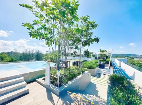 a swimming pool with a tree on the roof of a house at Bangtao Rooftop Seaview Laguna Skypark Condominium in Bang Tao Beach