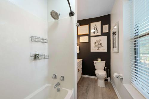 a bathroom with a toilet and a tub and a sink at The Luxe Pearl Residences 870-5 in Columbus