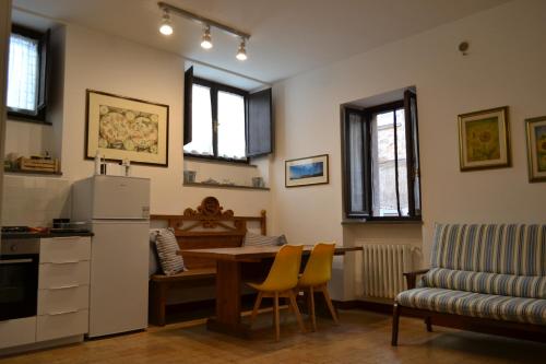 a kitchen with a table and a refrigerator and a table and chairs at Il Cavallino in Orvieto