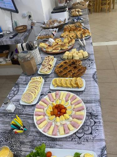 a long table with many plates of food on it at RondPoint Pilar in Pilar