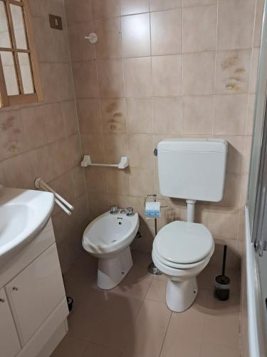 a bathroom with a toilet and a sink at il Battito in Saint Vincent