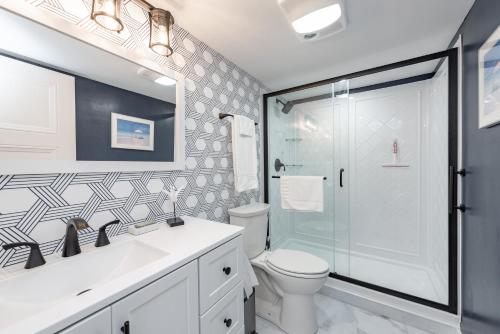 a bathroom with a shower and a toilet and a sink at 107B One Bedroom One Bath in Thayerville