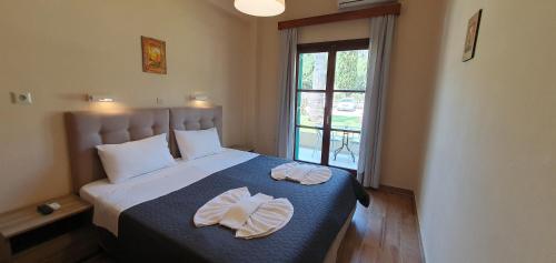 Postel nebo postele na pokoji v ubytování Phivos Hotel