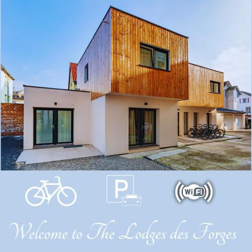 a picture of a house with a wooden facade at Les Lodges des Forges - Appartements Climatisés in Strasbourg
