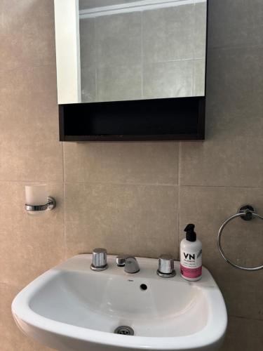 a white sink in a bathroom with a mirror at Bnb Loft XXIV in Rosario