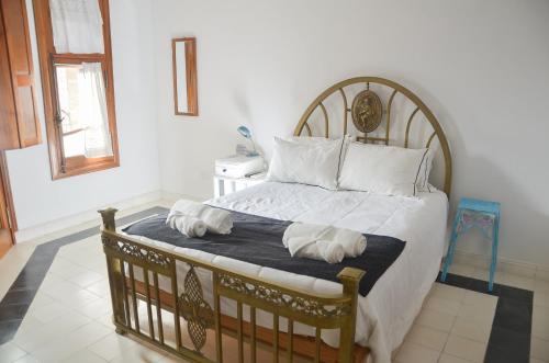 a bedroom with a large bed with two pillows on it at Posada Los Angelos in Ramallo