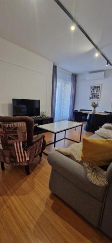 a living room with a couch and a table at Apartment Rose in Sesvete
