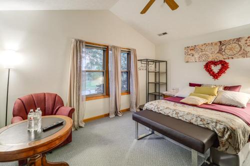 a bedroom with a bed and a table and a chair at Families Welcome! Spacious Suburban Home in Dayton in Murlin Heights