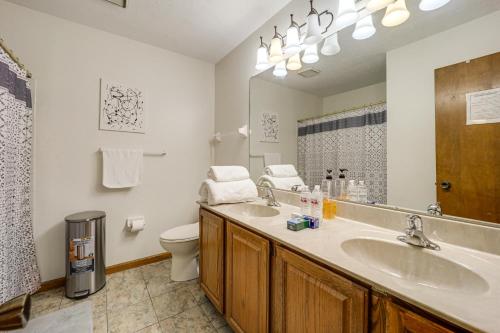 a bathroom with a sink and a toilet and a mirror at Families Welcome! Spacious Suburban Home in Dayton in Murlin Heights