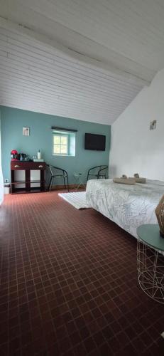 a bedroom with a bed and a desk in a room at Chambre Étape Isabielle in Saint-Vaury