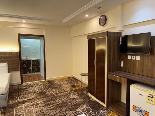 a hotel room with a bed and a flat screen tv at فندق طيف 1 in Quai