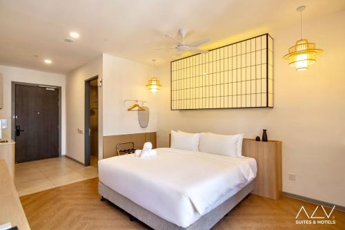a bedroom with a large white bed and a ceiling fan at 22 Macalisterz by ALV in George Town