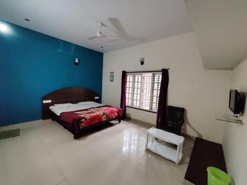 a bedroom with a bed and a window in it at Green Leaf Nature HomeStay in Santaveri