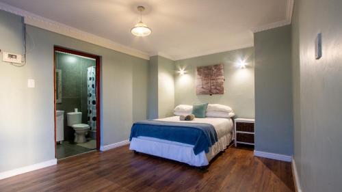 a bedroom with a bed and a bathroom at Bergriver Nest in Velddrif