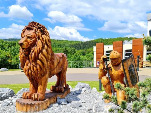 a statue of a lion standing next to a sign at Hasseröder Burghotel in Wernigerode