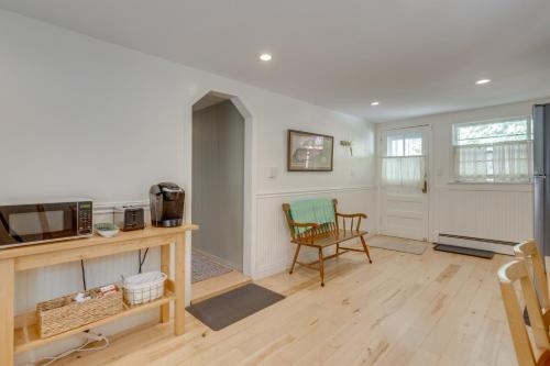 a living room with a table and a chair at No Pet Fee! Home with Private Yard in Rocky Point in Rocky Point