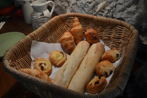 a basket filled with different types of pastries and bread at Chambre La Louve in Berrias Et Casteljau