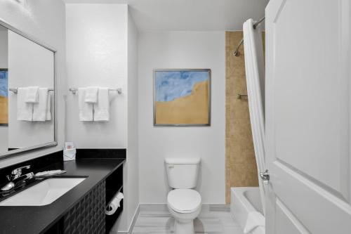a bathroom with a toilet and a sink and a shower at Comfort Inn & Suites Fort Smith I-540 in Fort Smith