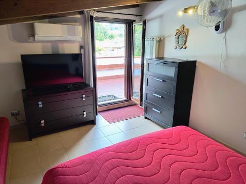 a bedroom with a bed and a dresser and a television at MAREMONTI alloggio turistico in Formia