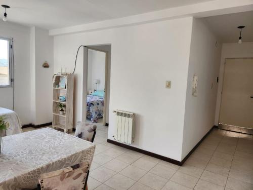 a white room with a table and a mirror at Alma Jujeña in San Salvador de Jujuy