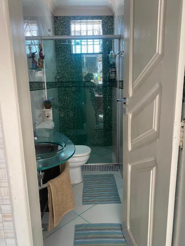 a bathroom with a shower and a toilet and a sink at Casa Cop 30 in Belém