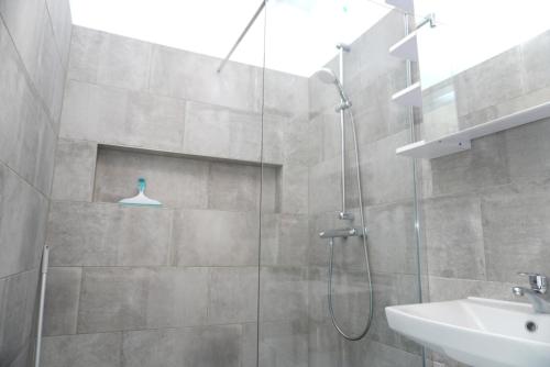a bathroom with a shower and a sink at Appartements Lena. in Premantura