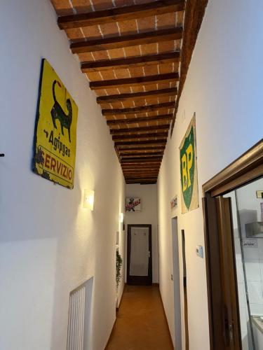 a hallway in a building with a sign on the wall at BACCANO Guest House in Montepulciano