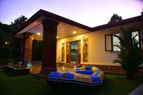 a house with a large inflatable bed in the yard at The New Crown Hotel in Dambulla