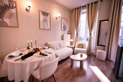 a living room with a table and a couch at Appart Centre-ville, Cathédrale, Petite France in Strasbourg