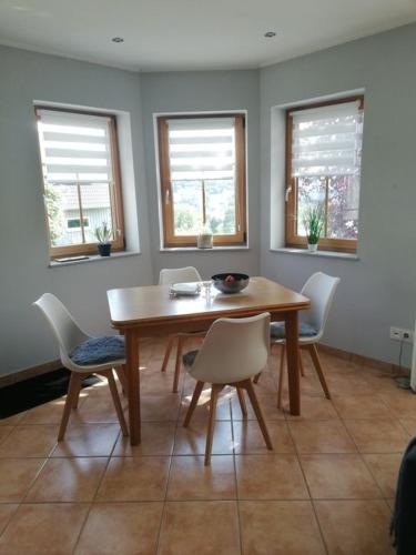 a dining room with a wooden table and chairs at Himmelthal Apartment in Eschau
