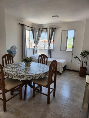 a dining room with a table and chairs and a bed at Abrazo del Norte in San Salvador de Jujuy