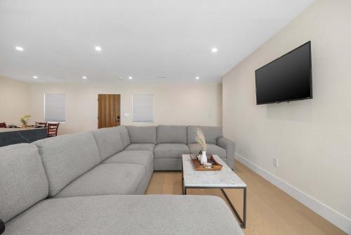 a living room with a couch and a flat screen tv at New Listing Valley Villa by Colby & Conrad in Winnetka