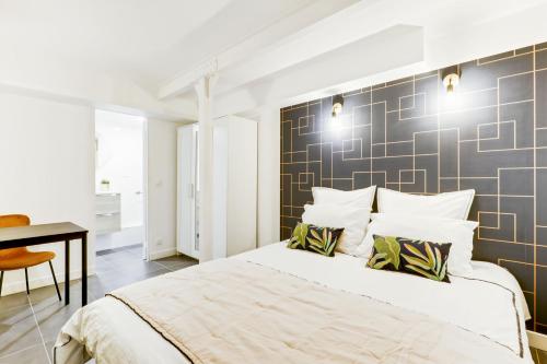 a bedroom with a large bed and a desk at Convinient souplex basement 5mn near métro and Montmartre in Paris
